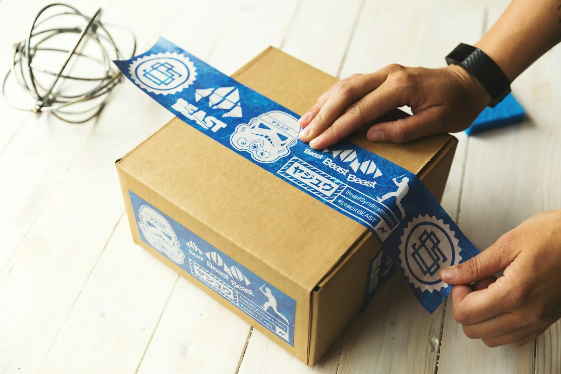 Hands sealing a parcel with packing tape